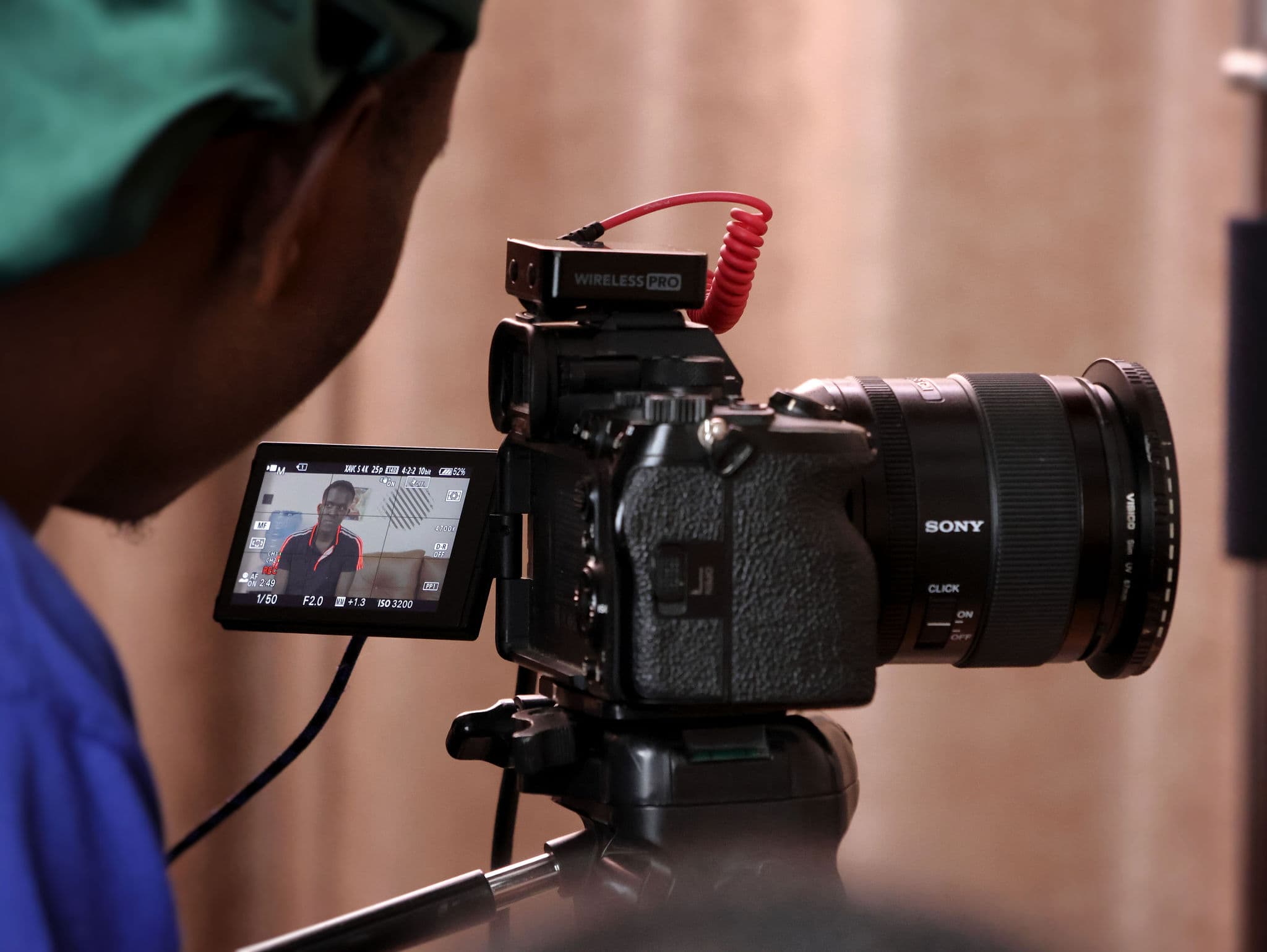 A camera operator framing a shot on the Mind Games set